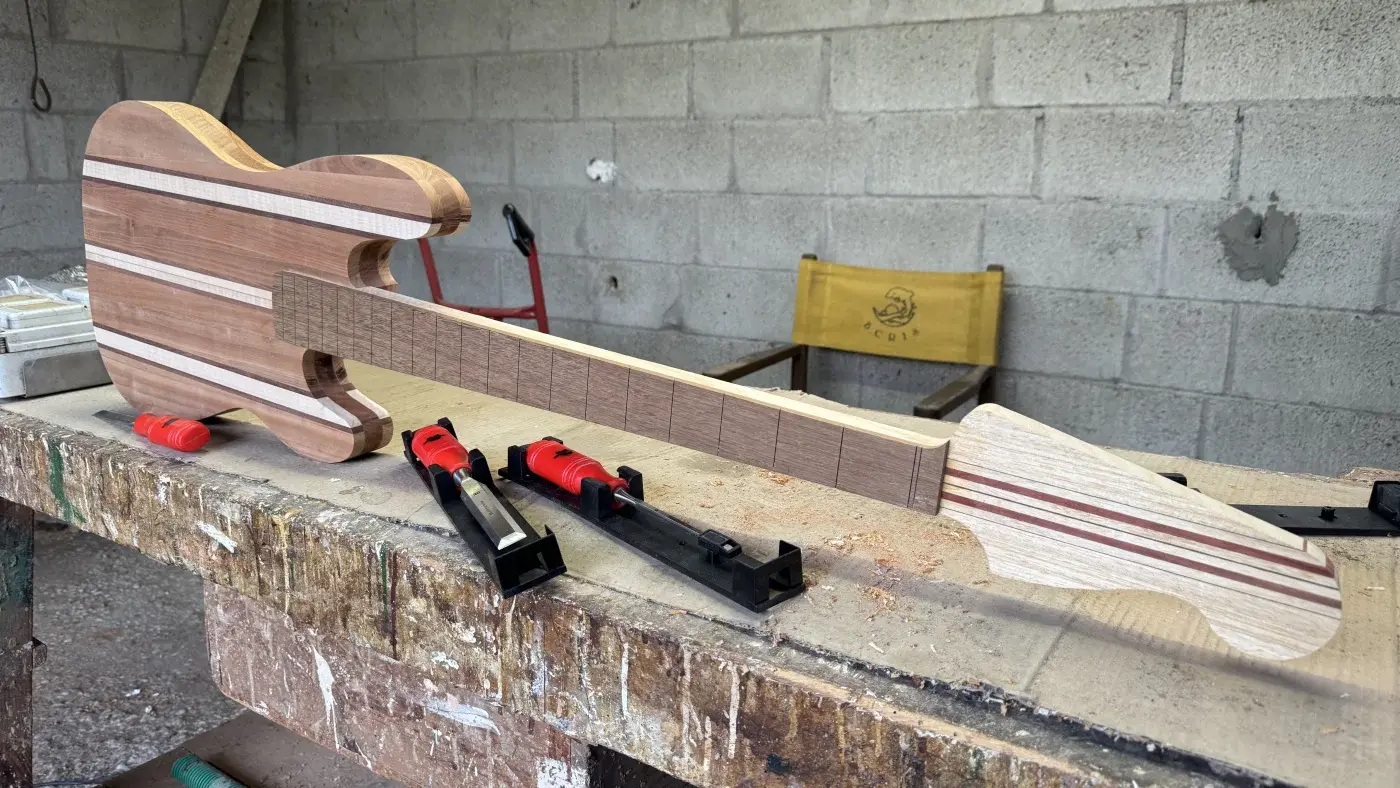 Body e manico del Precision Bass laminato a strisce di ciliegio mogano e acero assemblati per la prima volta in officina, vista frontale completa
